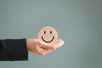 Wooden happy smile relax face on hand people. Spirit wellbeing health concept. Good feedback rating...