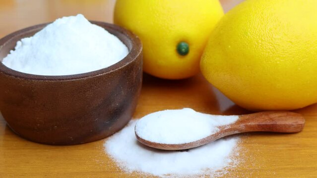 Citric acid white powder, Lemon extract is used as raw material, wood background 
