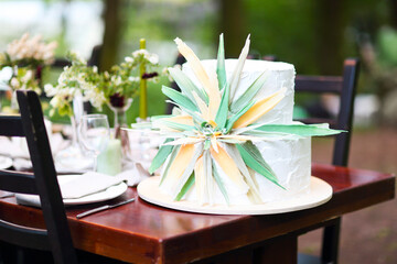Beautiful wedding cake with flower on table