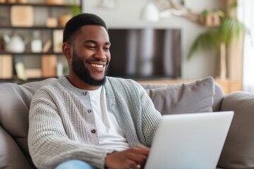 Smiling Man Using Laptop in Cozy Living Room