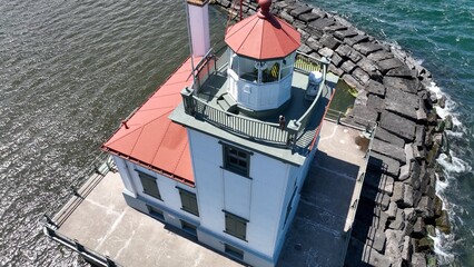 Lighthouse in Oswego New York close up on Lake Ontario at the mouth of Oswego River and harbor in...