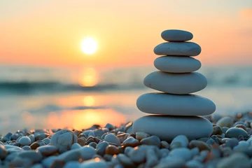 Tuinposter Experience tranquility through our image of a beach with a balanced pebble pyramid, symbolizing zen, meditation, and the soothing concept of balance and calmness. © Rathnayakamudalige