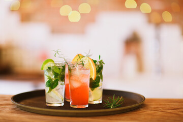 Two cocktail glasses on tray in the bar