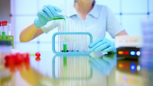 female laboratory assistant in a food laboratory follows the safety of preservatives, emulsifiers and other food additives