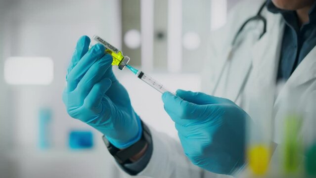 Preparation of medicine. An anesthesiologist, working in protective gloves, prepares medicine for anesthesia. Using modern drugs, a qualified doctor fills the syringe, providing effective treatment