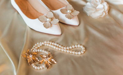 Weddings women white shoes with no heels with a flowers and pearls. Concept of Wedding, accessorize