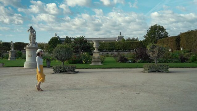 Beautiful young girl walking through a park in Paris, France