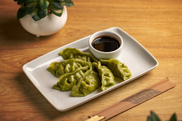 Platter of steamed Chinese spinach filling dumplings