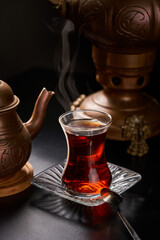 Turkish tea cup with copper utensils and teapot