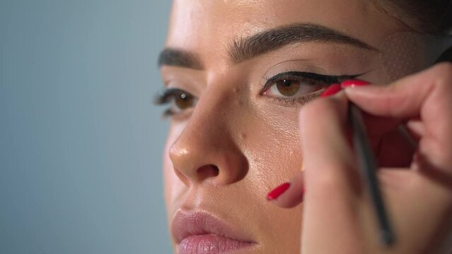 Fashion make-up fot young sexy woman. Close up visage, cosmetic, mascara. Makeup artist applying foundation skin, blusher and powder. Beautiful woman face. Beauty sensual girl with perfect skin.