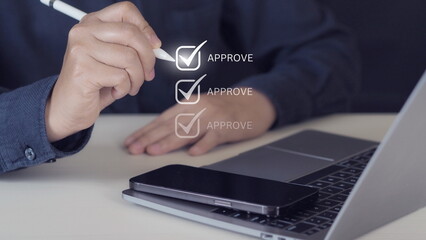 Businessman hand with pen to correct sign symbol mark on approve box for document approval