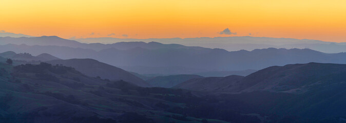 Sunrise, sunset, over orange sky mountains