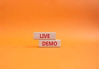 Live Demo symbol. Concept word Live Demo on wooden blocks. Beautiful orange background. Business...