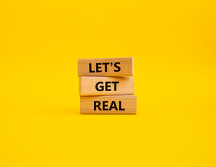 Naklejka premium Lets get real symbol. Concept words Lets get real on wooden blocks. Beautiful yellow background. Business and Lets get real concept. Copy space.