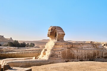 Giza, Egypt - December 24 2023: The iconic Sphinx carving adjacent to the Great Pyramids