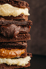 Stack of chocolate brownie and filling with dulce de leche, powdered milk, milk brigadeiro and beijinho