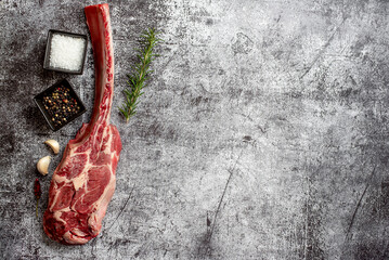 raw Steak 
Tomahawk on stone background with copy space for your text	
