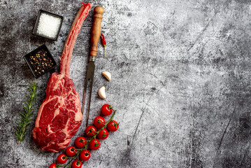 raw Steak 
Tomahawk on stone background with copy space for your text	
