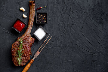 Grilled Tomahawk steak on stone background with copy space for text

