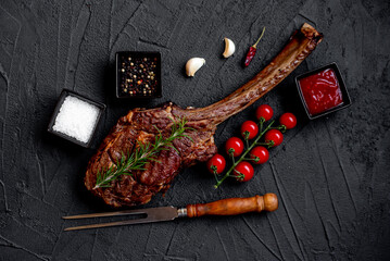 Grilled Tomahawk steak on stone background 