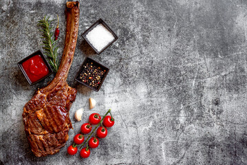 Grilled Tomahawk steak on stone background with copy space for text

