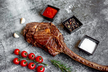 Grilled Tomahawk steak on stone background 