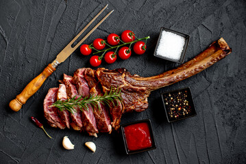 Grilled Tomahawk steak on stone background 