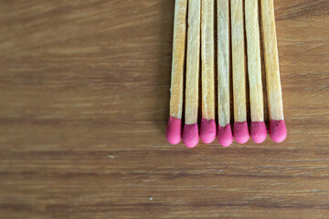Many matches on the wooden table, closeup