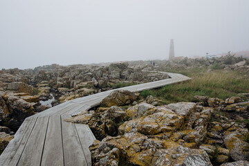 Møllenæsstien in Allinge, Bornholm. Walking on a wooden path through granite landscape near the...