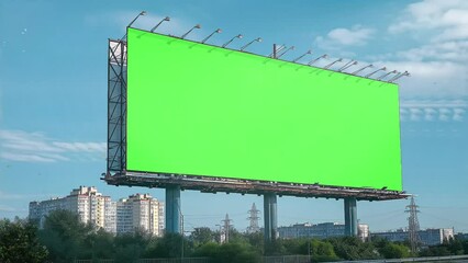 Blank green screen billboard with cityscape background at day time street advertising video mockup