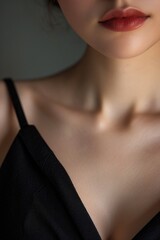 A close-up shot of a woman wearing a black dress. Versatile image for fashion, beauty, or formal event themes