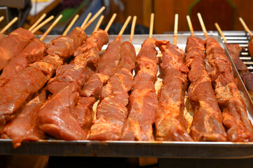 Marinated meat ready for grilling. Skewers prepared for barbeque.