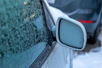 a frozen car mirror in winter