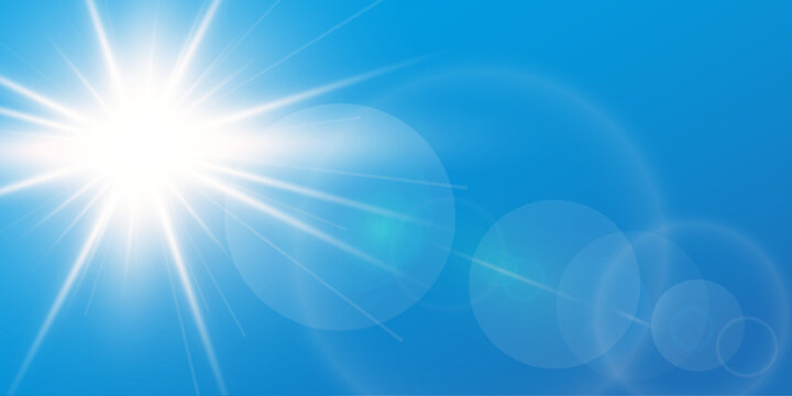 Blue sky background with bright sun and lens flare
