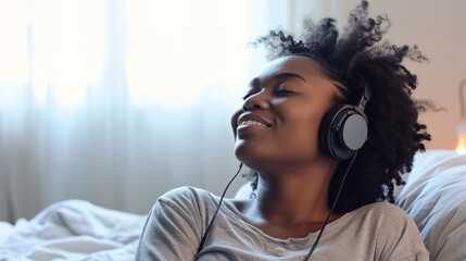 A young African American woman listens to music with pleasure, relaxes, immersing herself in the melody and her own thoughts. Creative concept for relaxation - obrazy, fototapety, plakaty