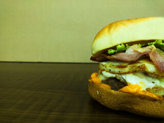 Partial view of craft burger on the wooden table and with copy space and white background