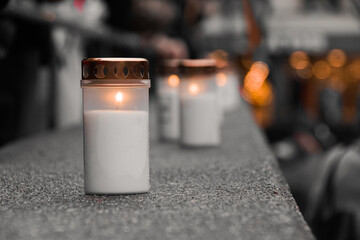 close-up of memorial candles on a wall in the city