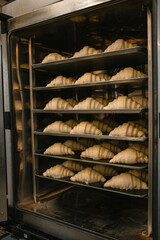 raw croissants in the baking oven