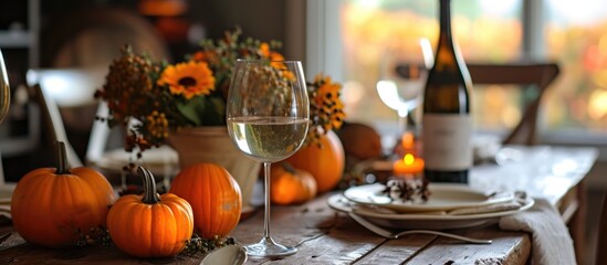 Fototapeta na wymiar Autumn-inspired countryside decor with pumpkins, wine for a cozy indoor Thanksgiving dinner.