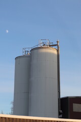 Fototapeta na wymiar grain storage tank. industrial plant with chimney.