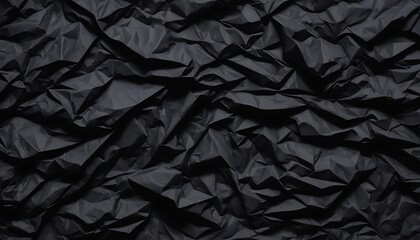 Black crumpled paper texture in low light background