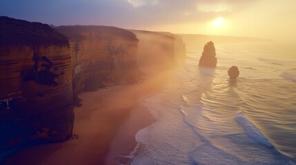 AERIAL: Spectacular drone point of view of the famous 12 Apostles beach in Australia on a sunny summer evening. Golden sunshine illuminates the cliffs and other rock formations on coast of Australia.  - obrazy, fototapety, plakaty