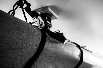 Selective focus on the side of a kayak that has used a Hoist and pulley system to store on the...