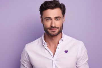 Obraz premium portrait of a young handsome man with violet hearts on his shirt on a lilac background. valentine's day.