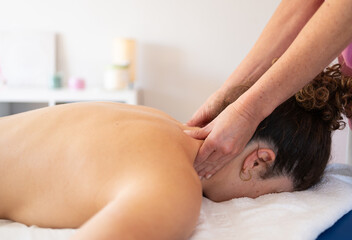 Obraz na płótnie Canvas Masseuse massaging neck of woman in spa salon