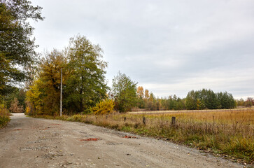 Fototapeta na wymiar A gravel road at rural Europe. Suburban road path