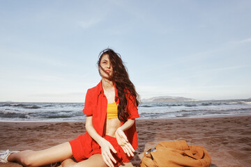 Fototapeta na wymiar Joyful Explorer: A Young Woman Backpacking in Nature, Relaxing at a Beautiful Seaside Beach.