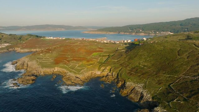 Aerial View of Rock Fence on The Mountain Hills Overlooking the Laxe Town and Beach in Spain