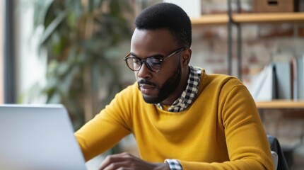 Black Man Sitting at Table Using Laptop Computer for Video Generative AI
