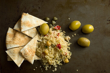 Macro Top View of Pita, Couscous, Olives, Capers and Chickpeas